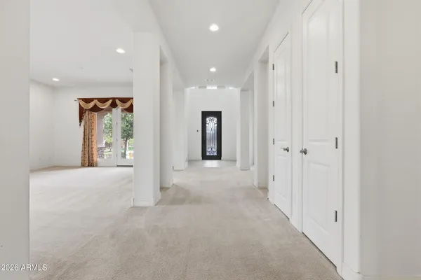 an empty room with windows and closet