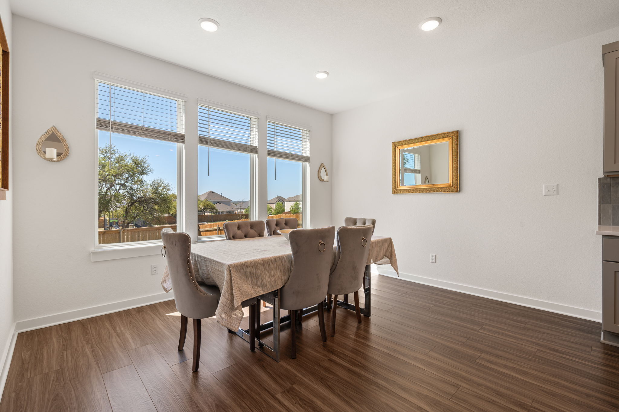 256 Comfort Maple Lane Dripping Springs, TX 78620 - Photo 12 of 39 The spacious dining area is bathed in natural light from expansive windows lining the rear wall.