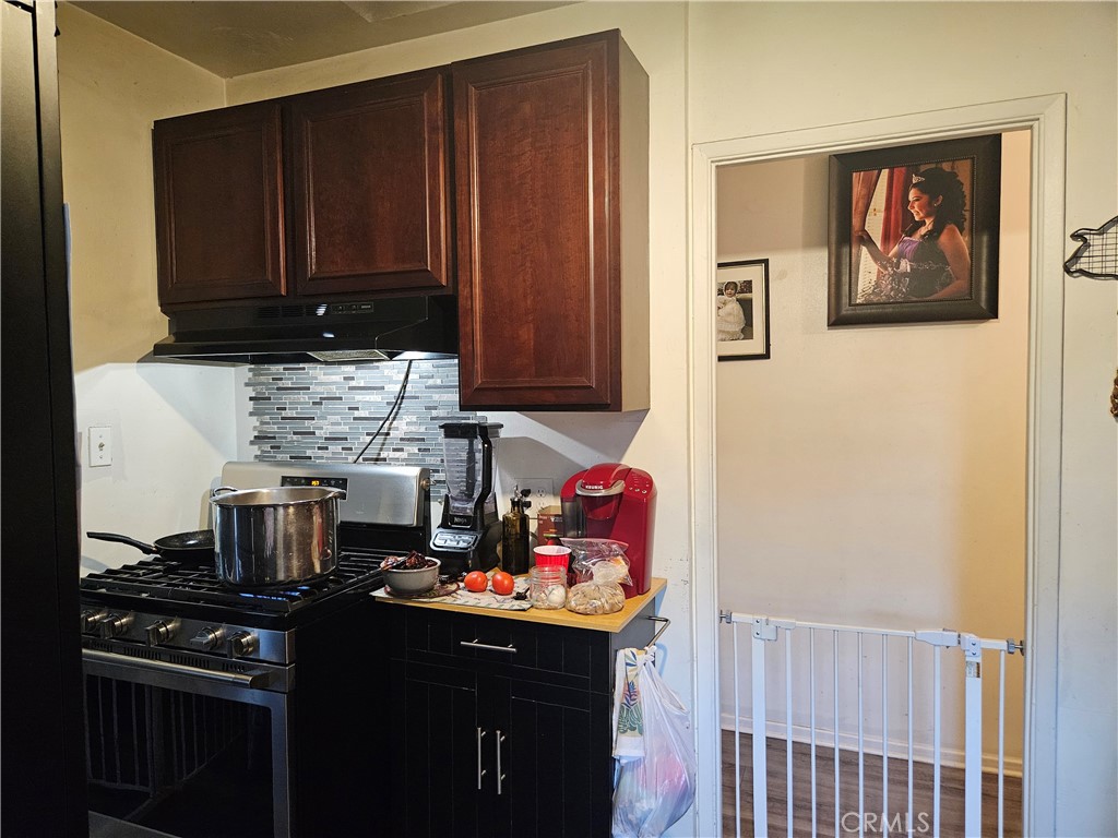 537 East 3rd Street Rialto, CA 92376 - Photo 20 of 47 a kitchen with a cabinets and a stove top oven