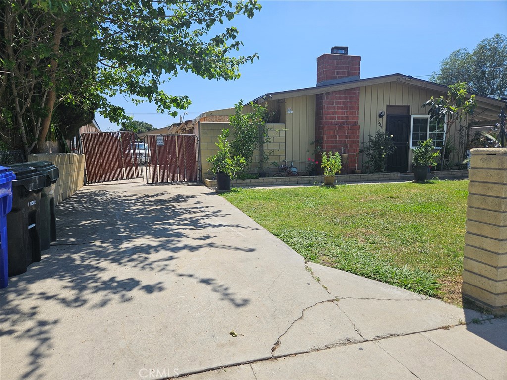 537 East 3rd Street Rialto, CA 92376 - Photo 3 of 47 a view of a big house with a yard and large tree