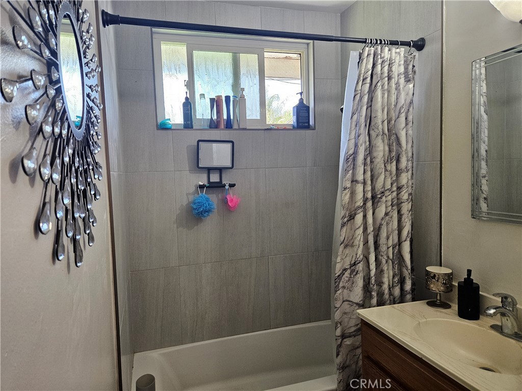 537 East 3rd Street Rialto, CA 92376 - Photo 41 of 47 a bathroom with a shower curtain and a sink