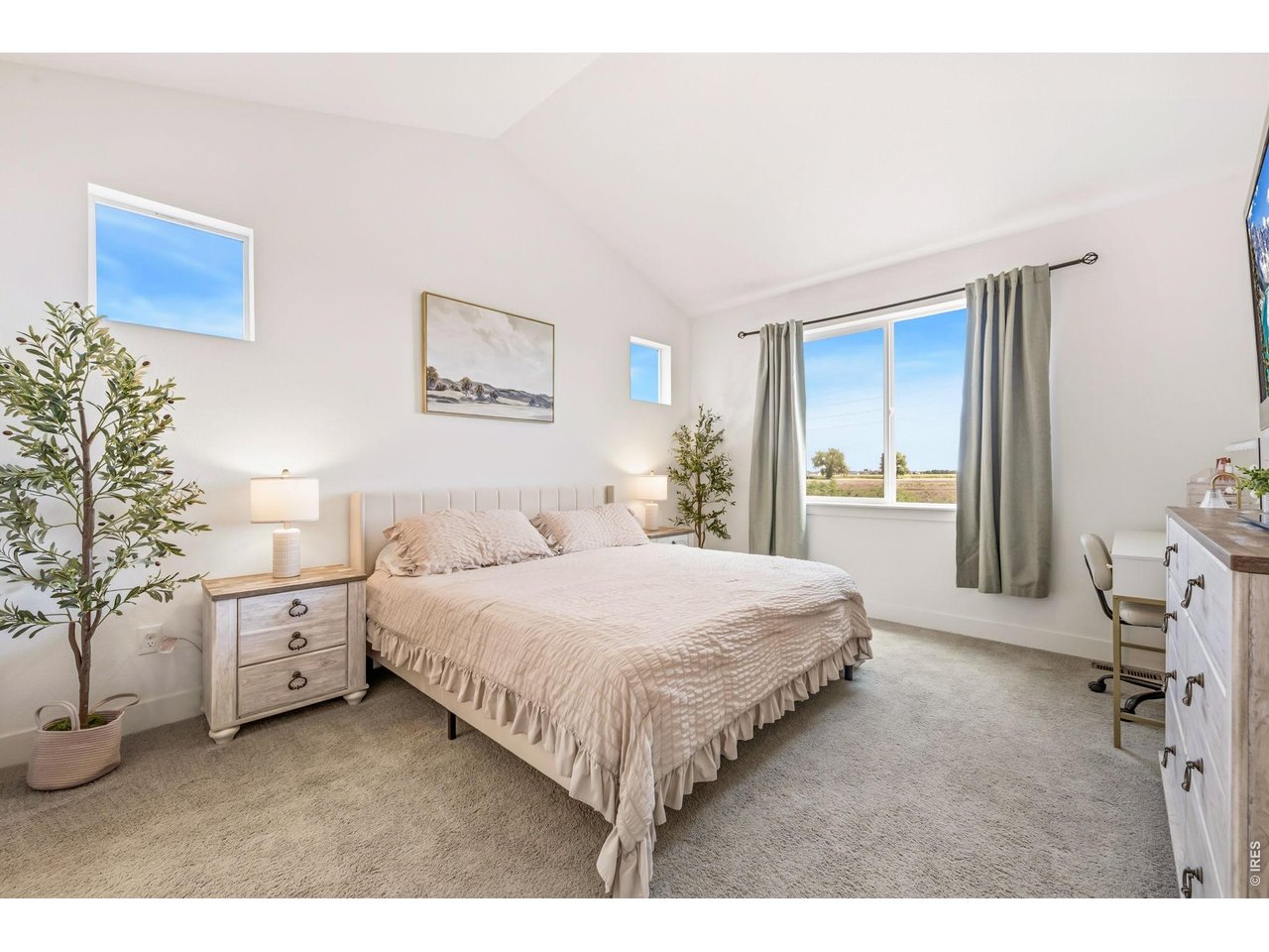 761 Muturu Road Johnstown, CO 80534 - Photo 10 of 35 A spacious primary bedroom welcomes you with a vaulted ceiling and natural light.
