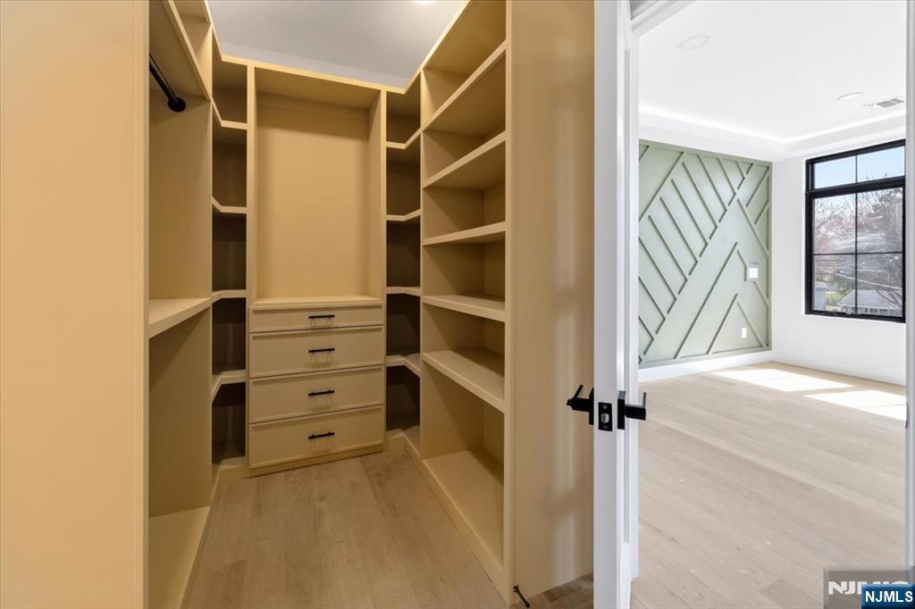 150 Howland Avenue River Edge, NJ 07661 - Photo 15 of 45 a view of walk in closet with empty racks
