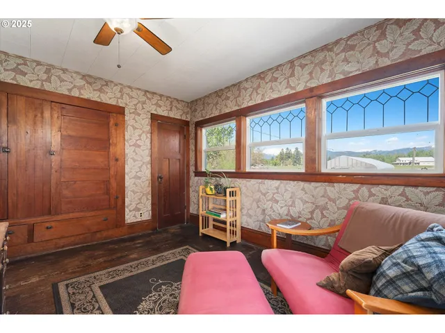 a living room with furniture rug and wooden floor