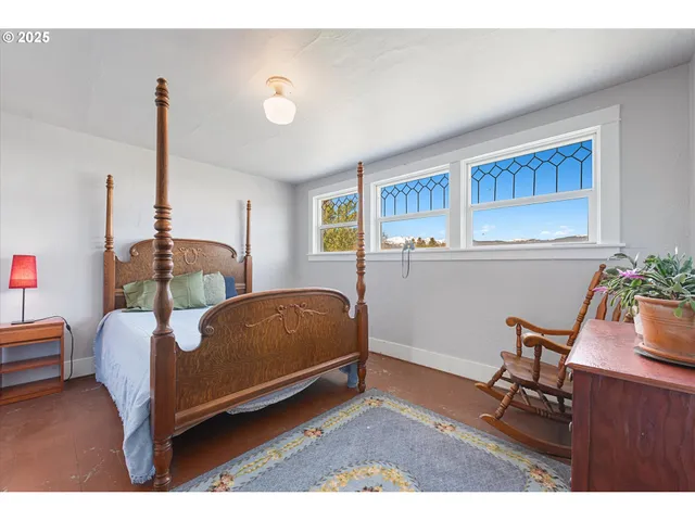 a bedroom with furniture and a wooden floor