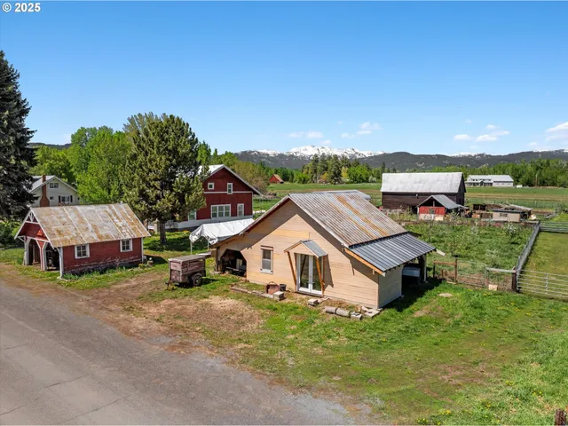 an aerial view of a house with swimming pool and a yard