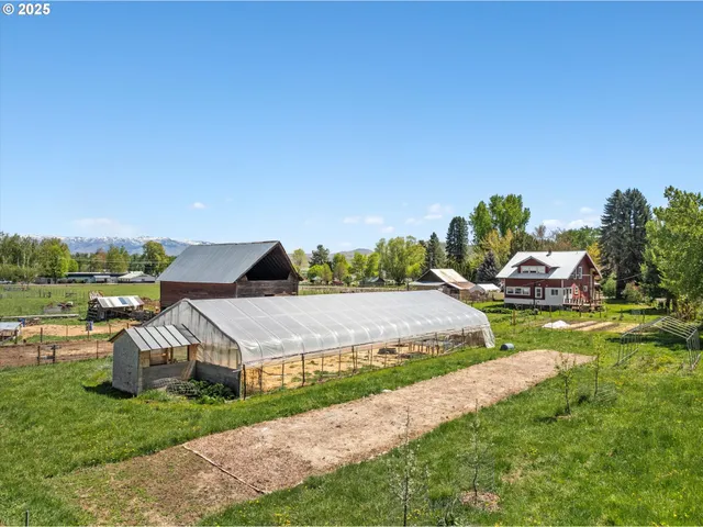 a aerial view of a house with big yard