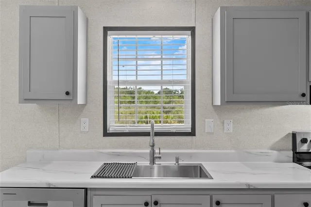 a kitchen with a sink and large window