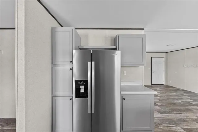 a metallic refrigerator freezer sitting in a kitchen