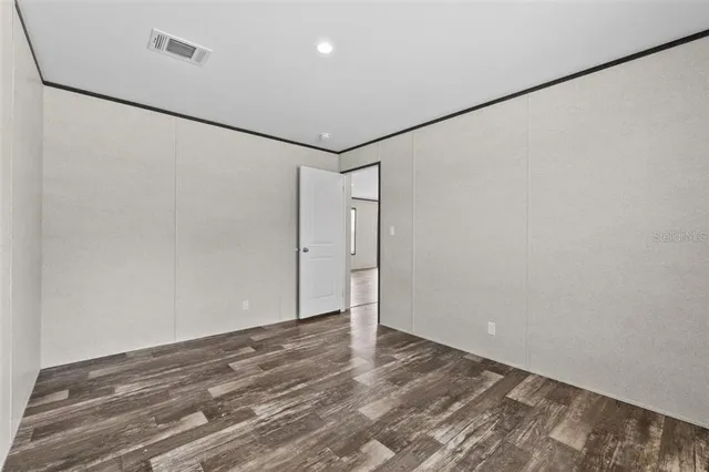 a view of a room with wooden floor