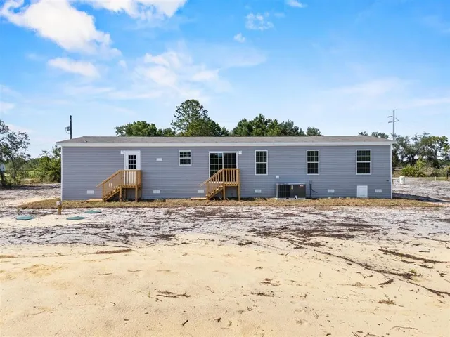 a view of a old house next to a yard and covered with snow
