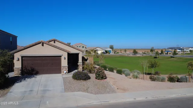 a view of a house with a yard and garage