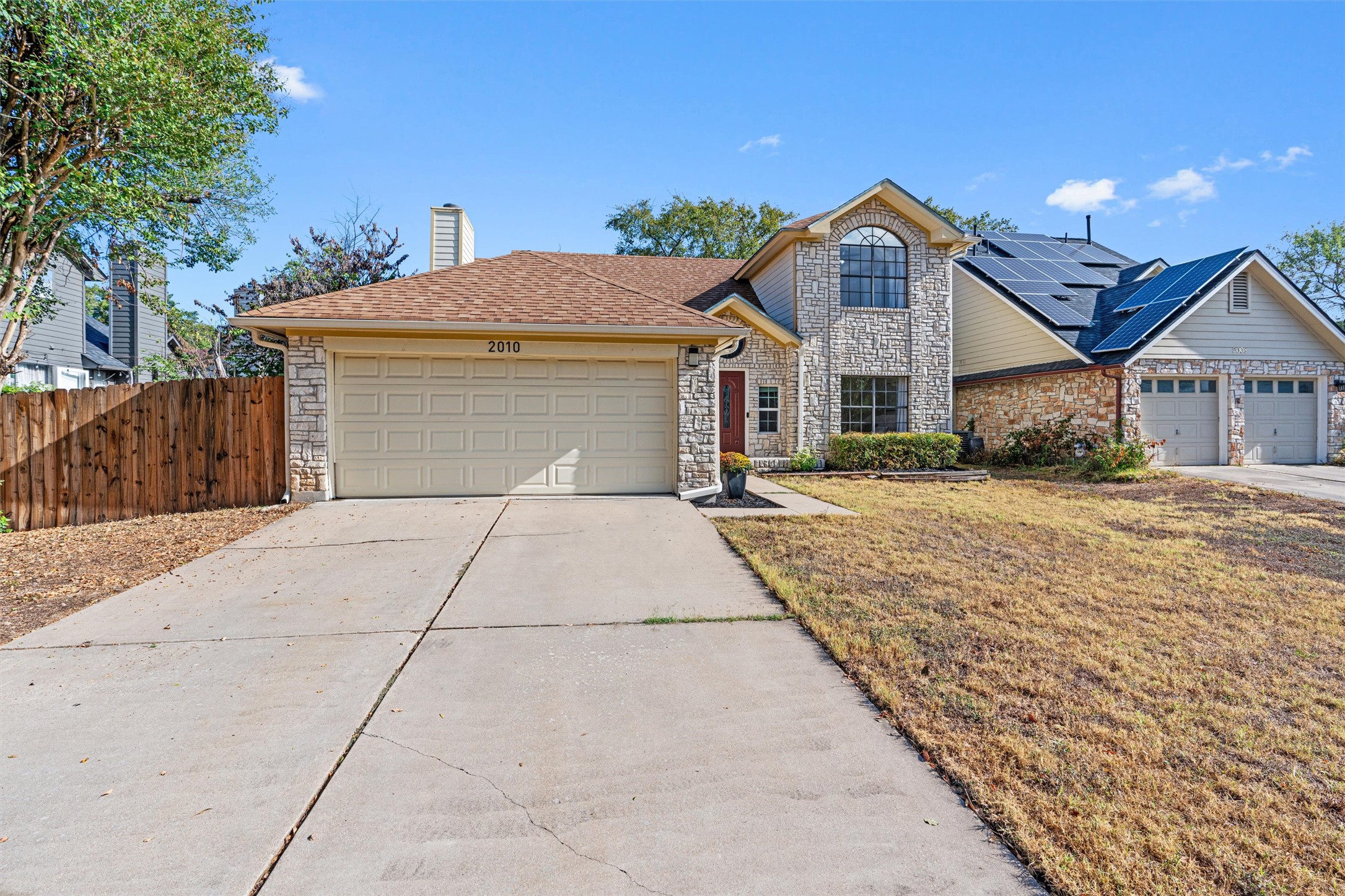 2010 Cervin Boulevard Austin, TX 78728 - Photo 2 of 32 a front view of a house with a yard and trees