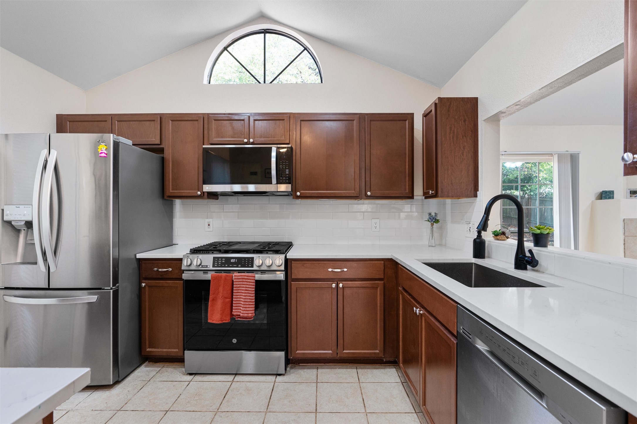 2010 Cervin Boulevard Austin, TX 78728 - Photo 7 of 32 a kitchen with stainless steel appliances a stove a sink a microwave and refrigerator
