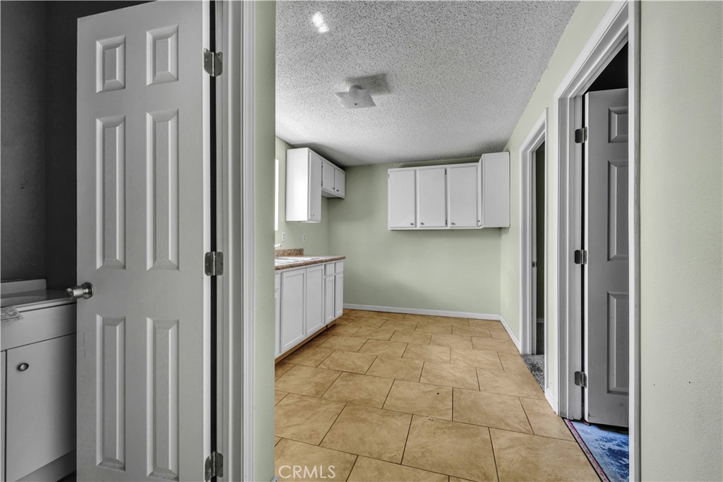 36806 Meadowview Court Palmdale, CA 93552 - Photo 11 of 17 a view of a kitchen with a sink and dishwasher cabinets