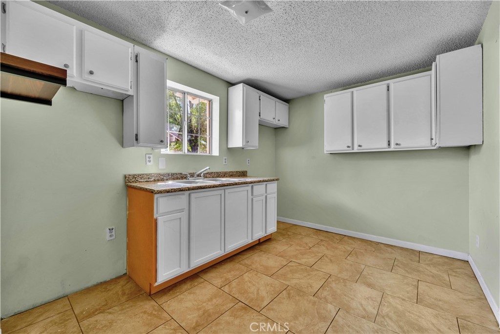 36806 Meadowview Court Palmdale, CA 93552 - Photo 12 of 17 a kitchen with stainless steel appliances granite countertop a stove a sink and a white cabinets