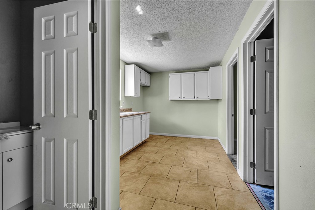 36806 Meadowview Court Palmdale, CA 93552 - Photo 13 of 17 a view of a kitchen with a sink and dishwasher cabinets