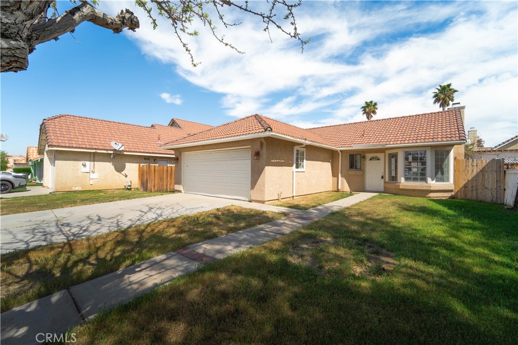 36806 Meadowview Court Palmdale, CA 93552 - Photo 17 of 17 a view of a yard in front of a house with a large tree