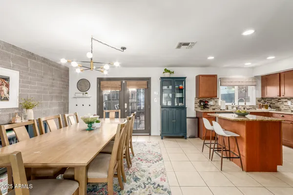 a large kitchen with a table and chairs