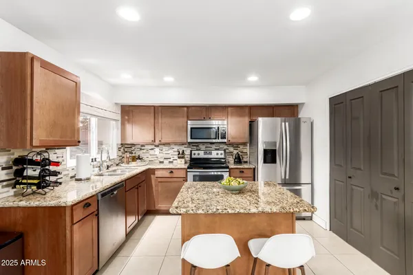 a kitchen with stainless steel appliances a sink stove and refrigerator