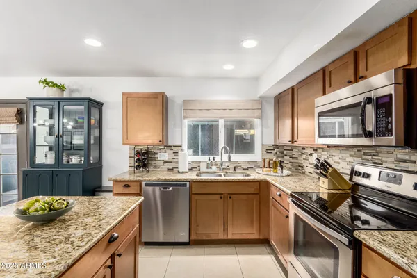 a kitchen with a sink stove and cabinets