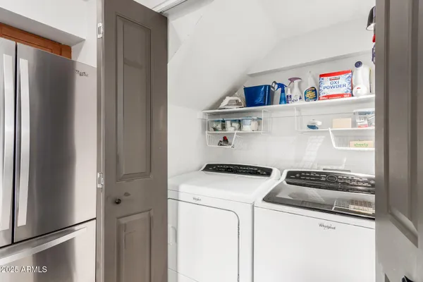 a view of storage and utility room with washer and dryer