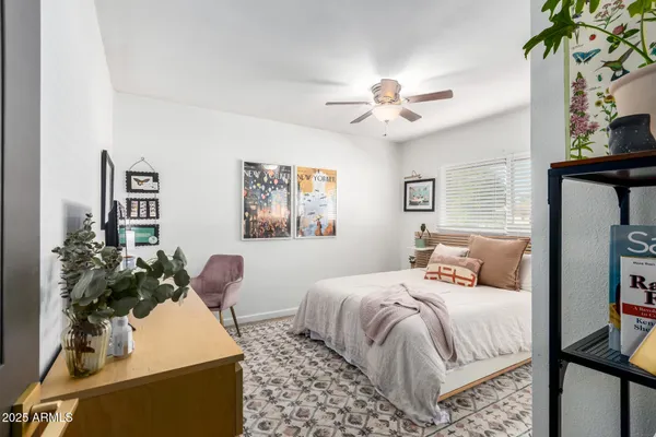 a bedroom with bed and a potted plant