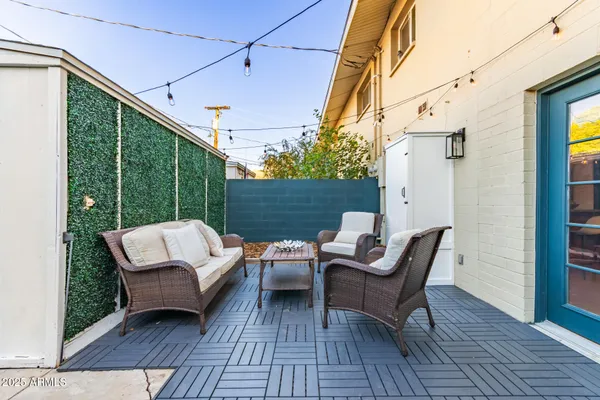 a view of a patio with a table and chairs