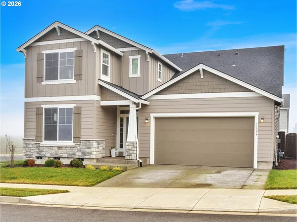 a front view of a house with a yard and garage