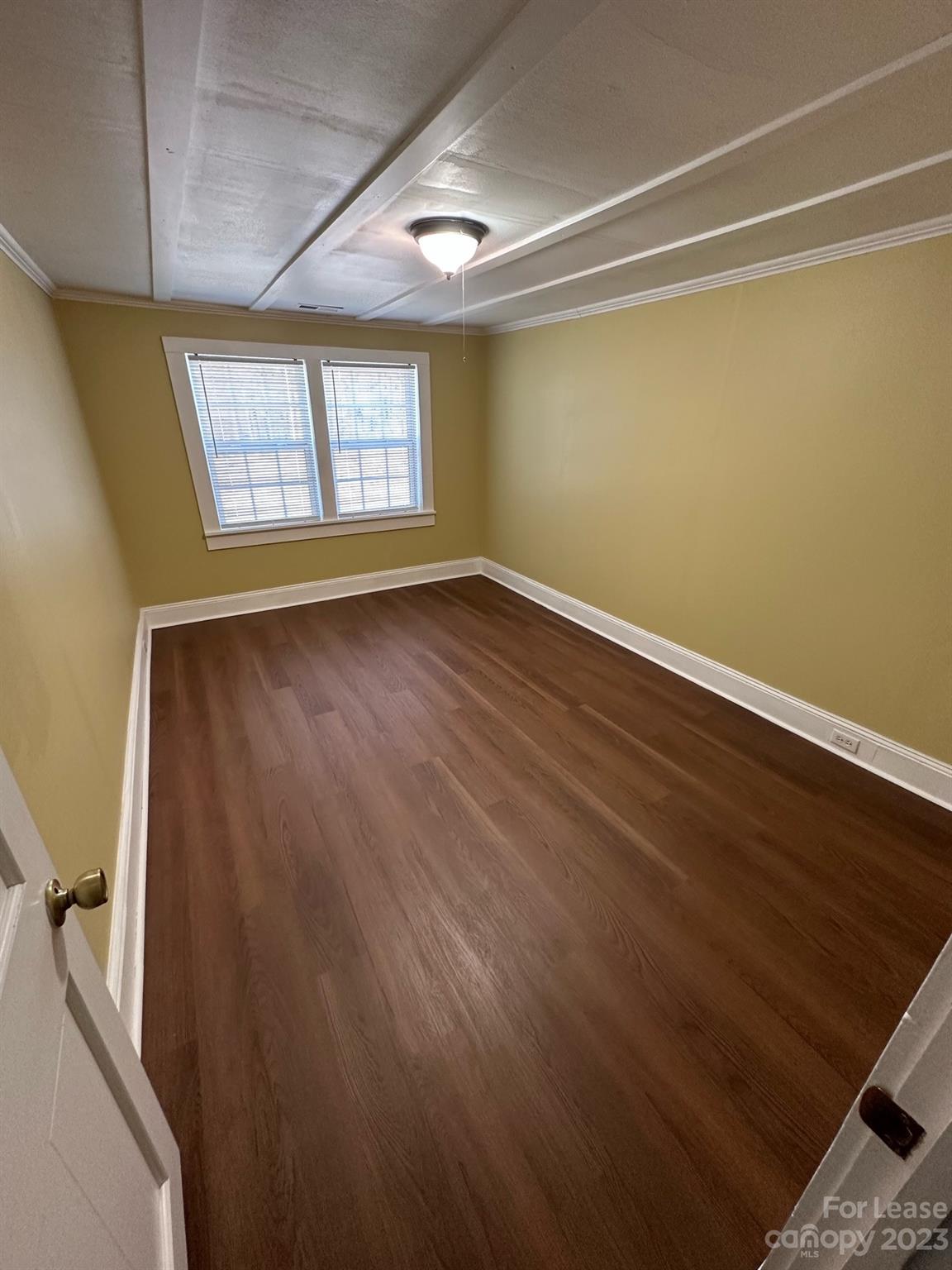 5650 Old Monroe Circle Concord, NC 28025 - Photo 6 of 11 an empty room with wooden floor and windows