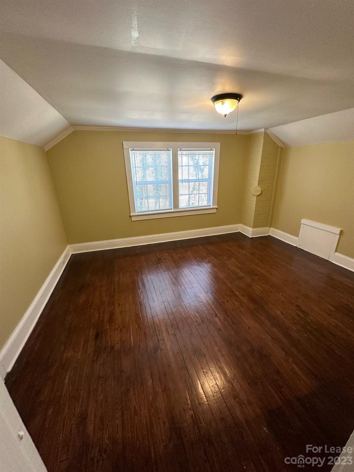 5650 Old Monroe Circle Concord, NC 28025 - Photo 7 of 11 an empty room with wooden floor and windows