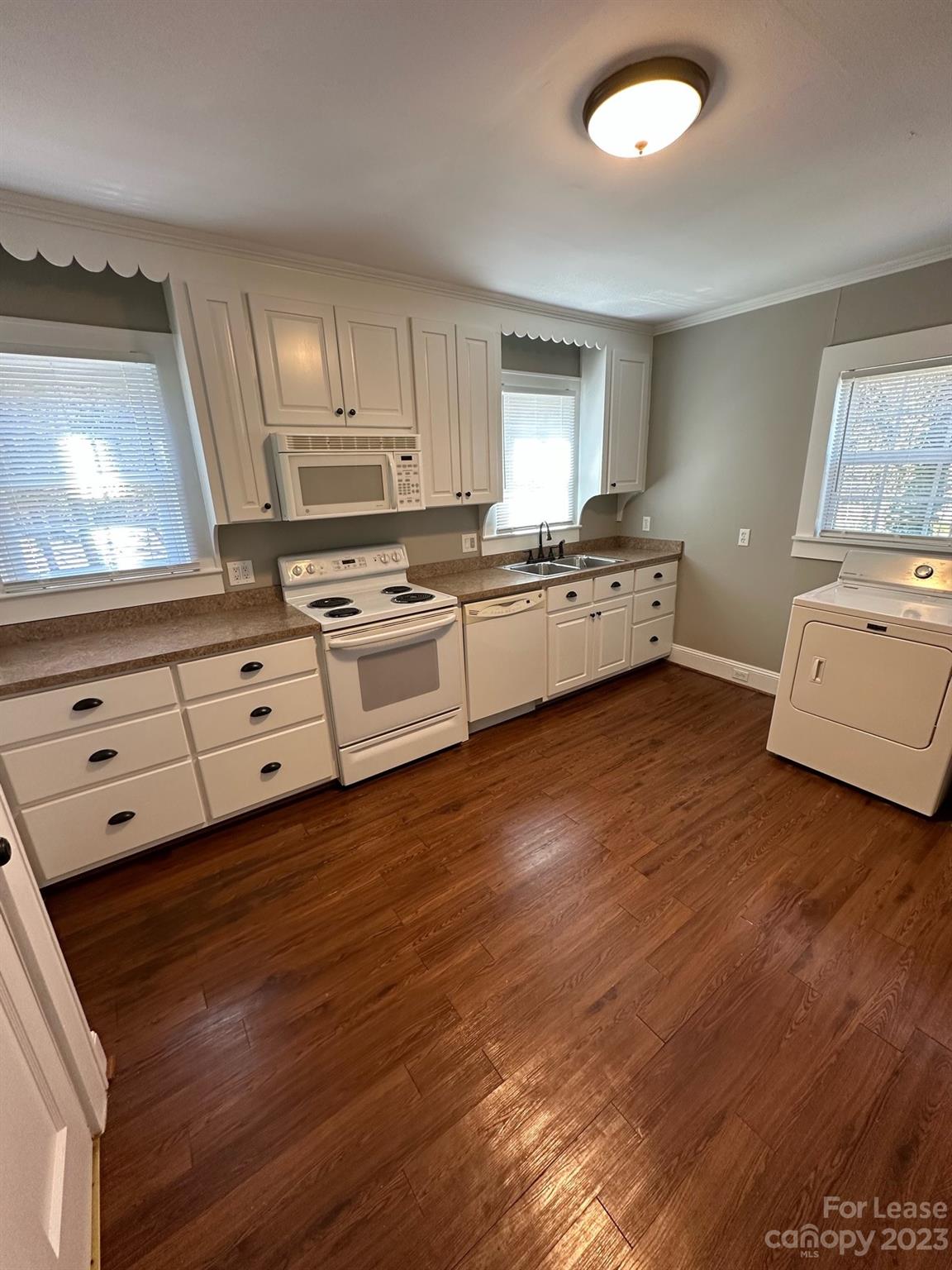 5650 Old Monroe Circle Concord, NC 28025 - Photo 10 of 11 a kitchen with granite countertop white cabinets and white appliances