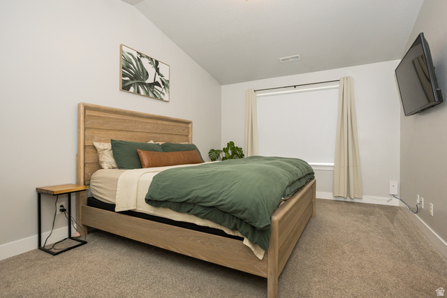 2452 West 500 South, Unit 2 Springville, UT 84663 - Photo 12 of 23 Carpeted room featuring a vaulted ceiling and a wide window with roller shade and drapes