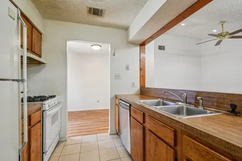 a kitchen that has a sink and a stove