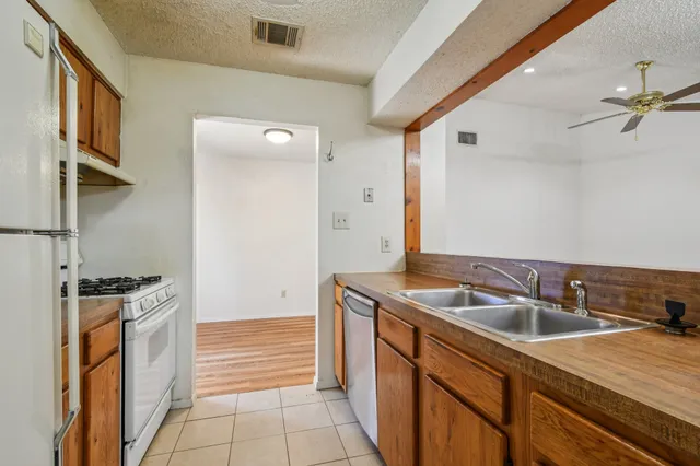 a kitchen that has a sink and a stove