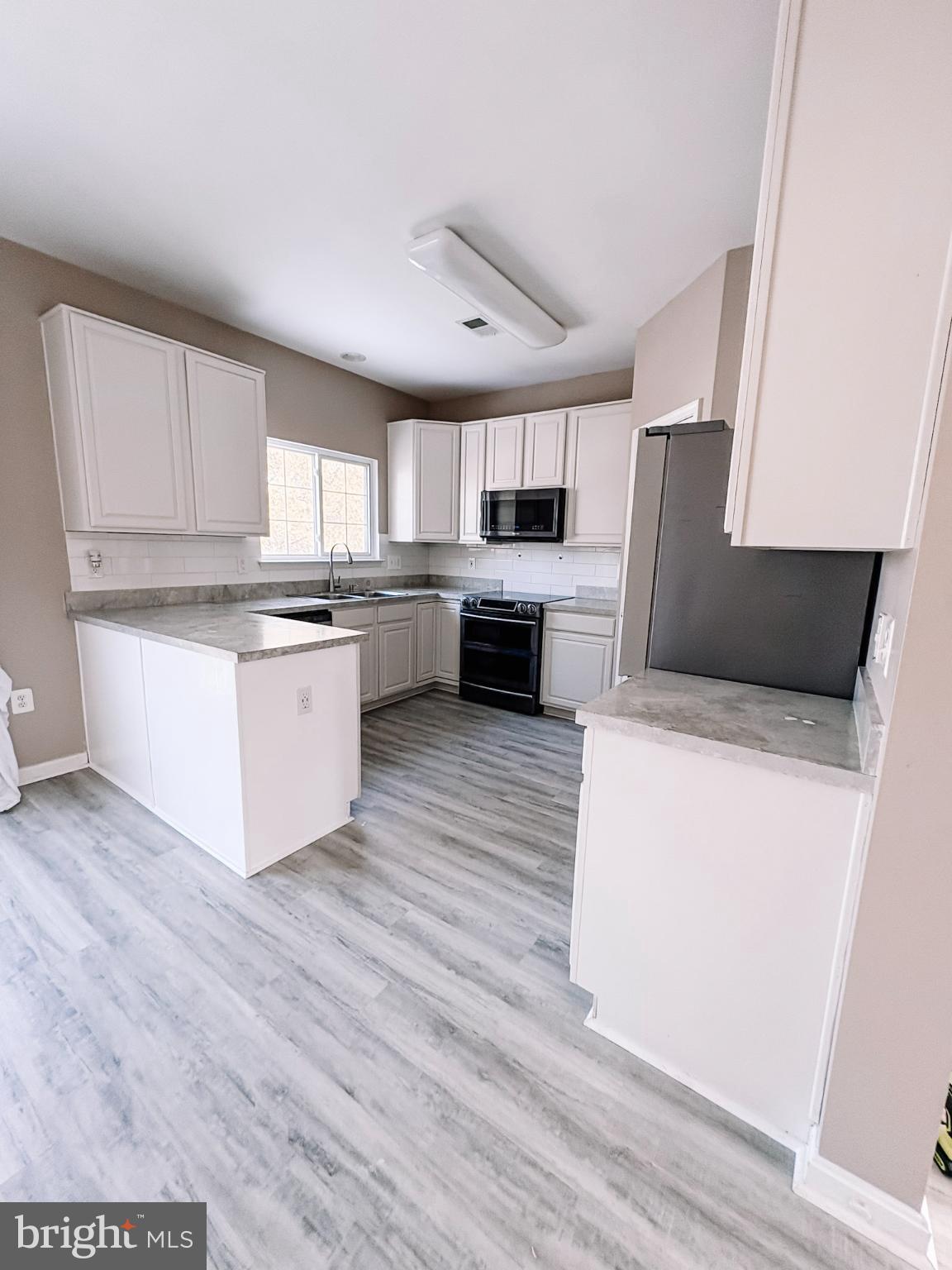 6151 Newton Lane Bealeton, VA 22712 - Photo 14 of 47 a kitchen with stainless steel appliances a refrigerator sink and cabinets