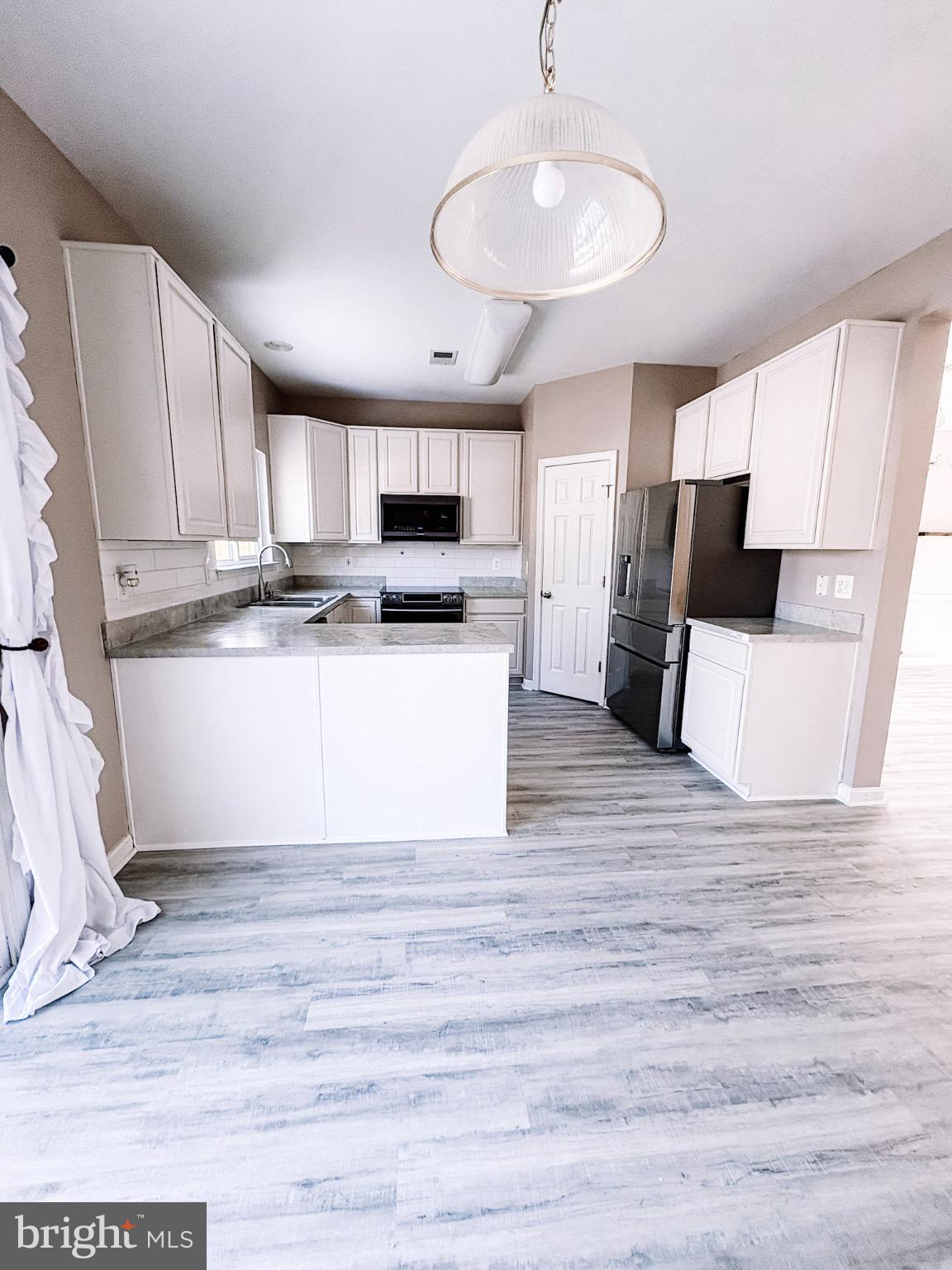 6151 Newton Lane Bealeton, VA 22712 - Photo 15 of 47 a kitchen with stainless steel appliances a refrigerator sink and microwave