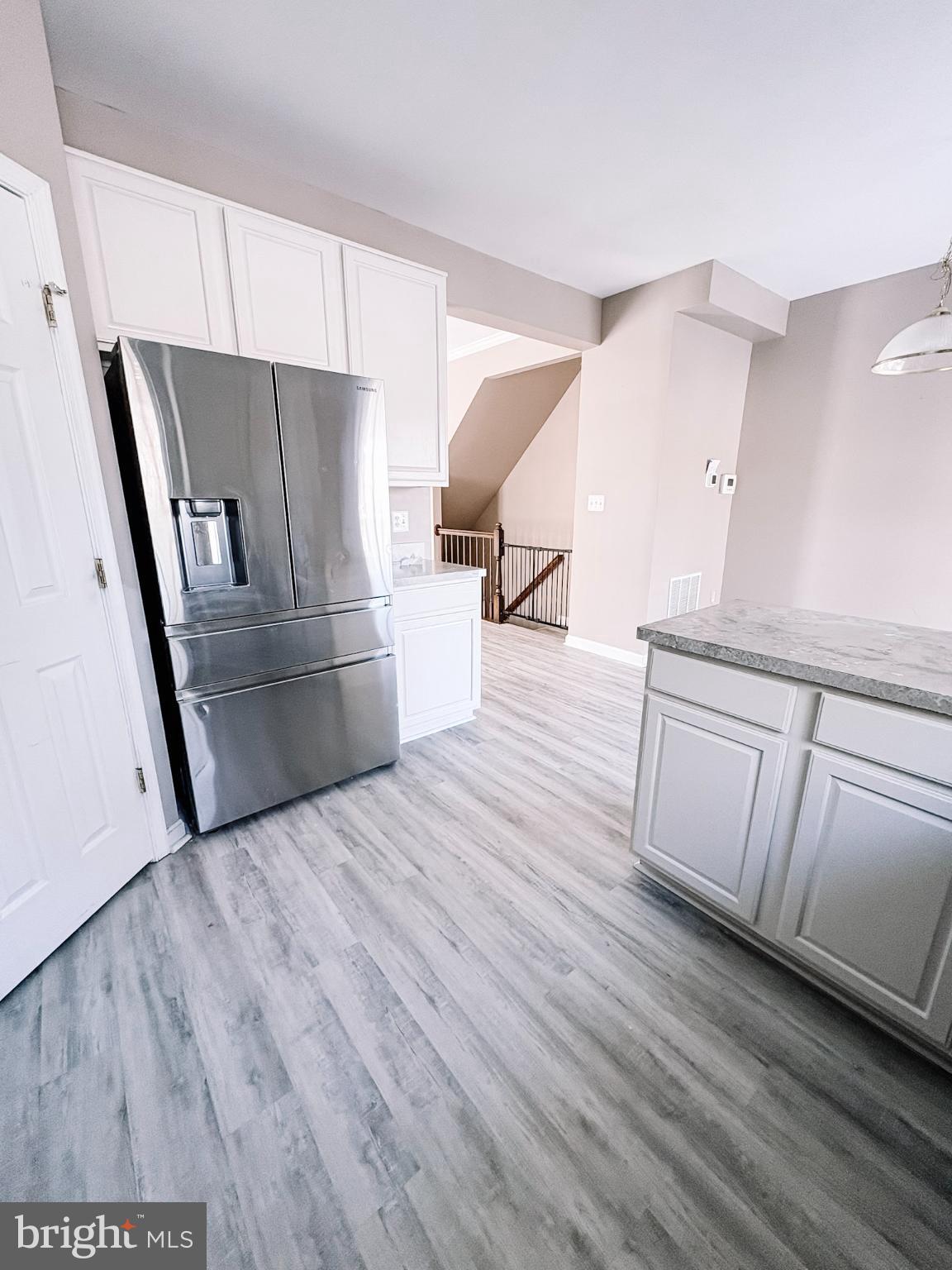 6151 Newton Lane Bealeton, VA 22712 - Photo 18 of 47 a kitchen with wooden floors and white appliances