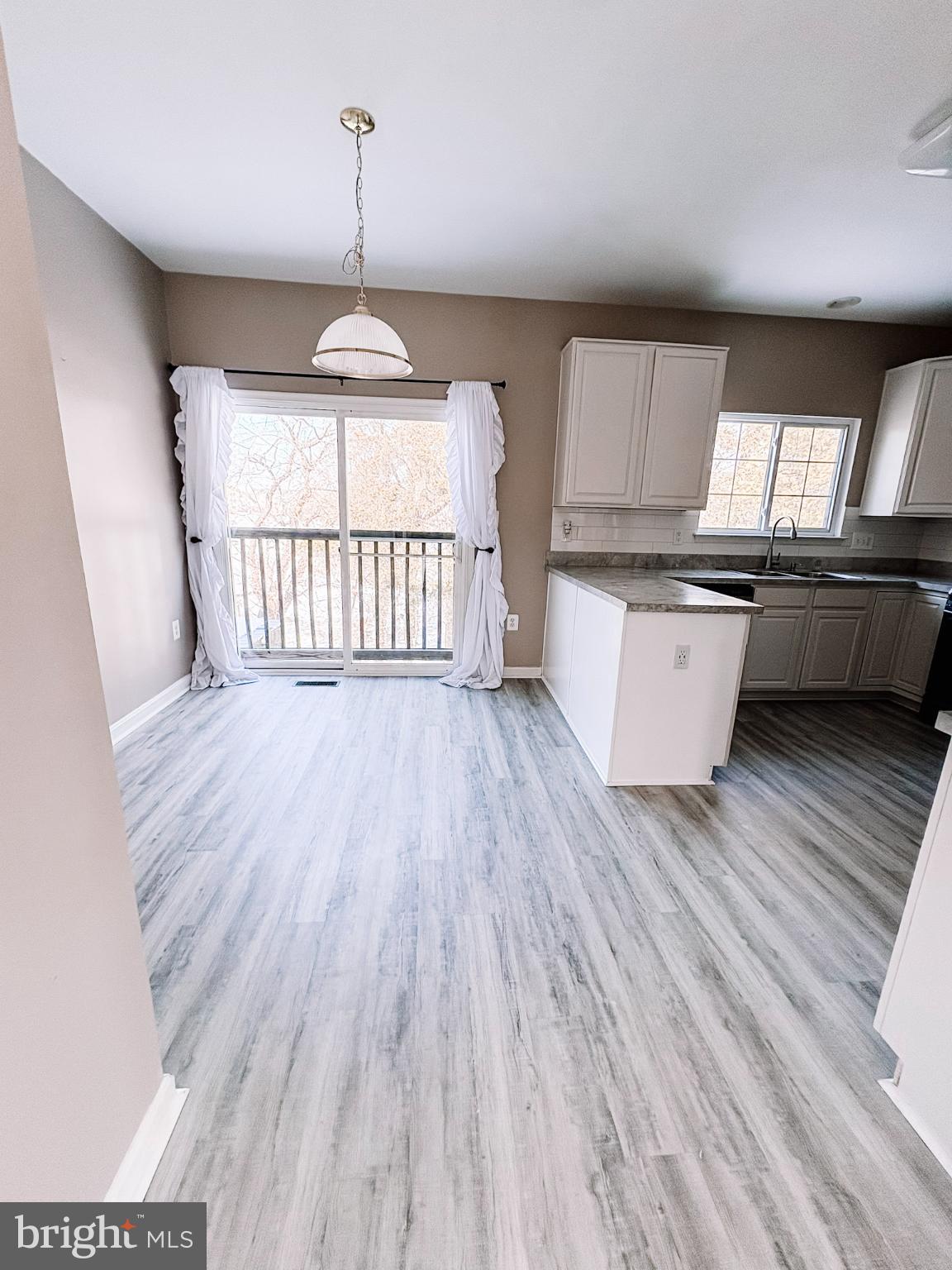 6151 Newton Lane Bealeton, VA 22712 - Photo 20 of 47 a open kitchen with kitchen island a stove a sink and a wooden floors