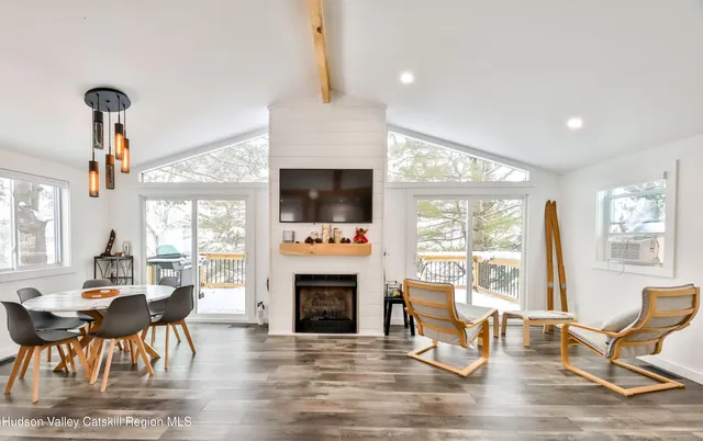 a living room with furniture a fireplace and a flat screen tv