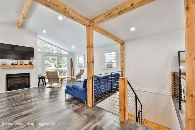a living room with furniture a fireplace and a flat screen tv