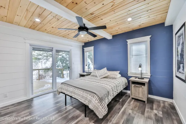 a bedroom with a balcony a bed and a window