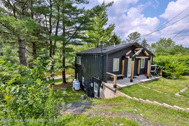 a view of a house with backyard and sitting area