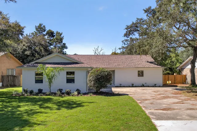 a front view of house with a garden