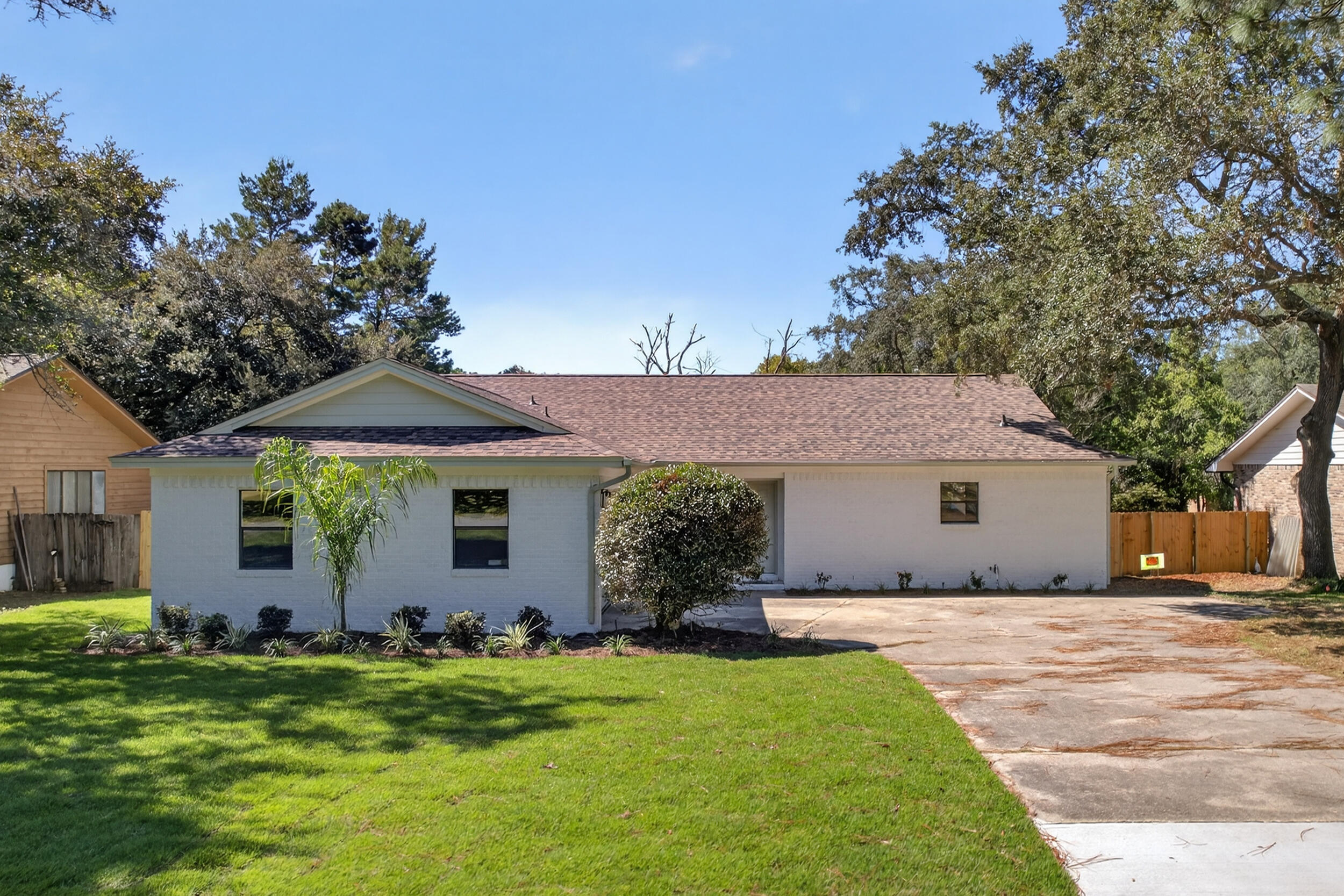 a front view of house with a garden