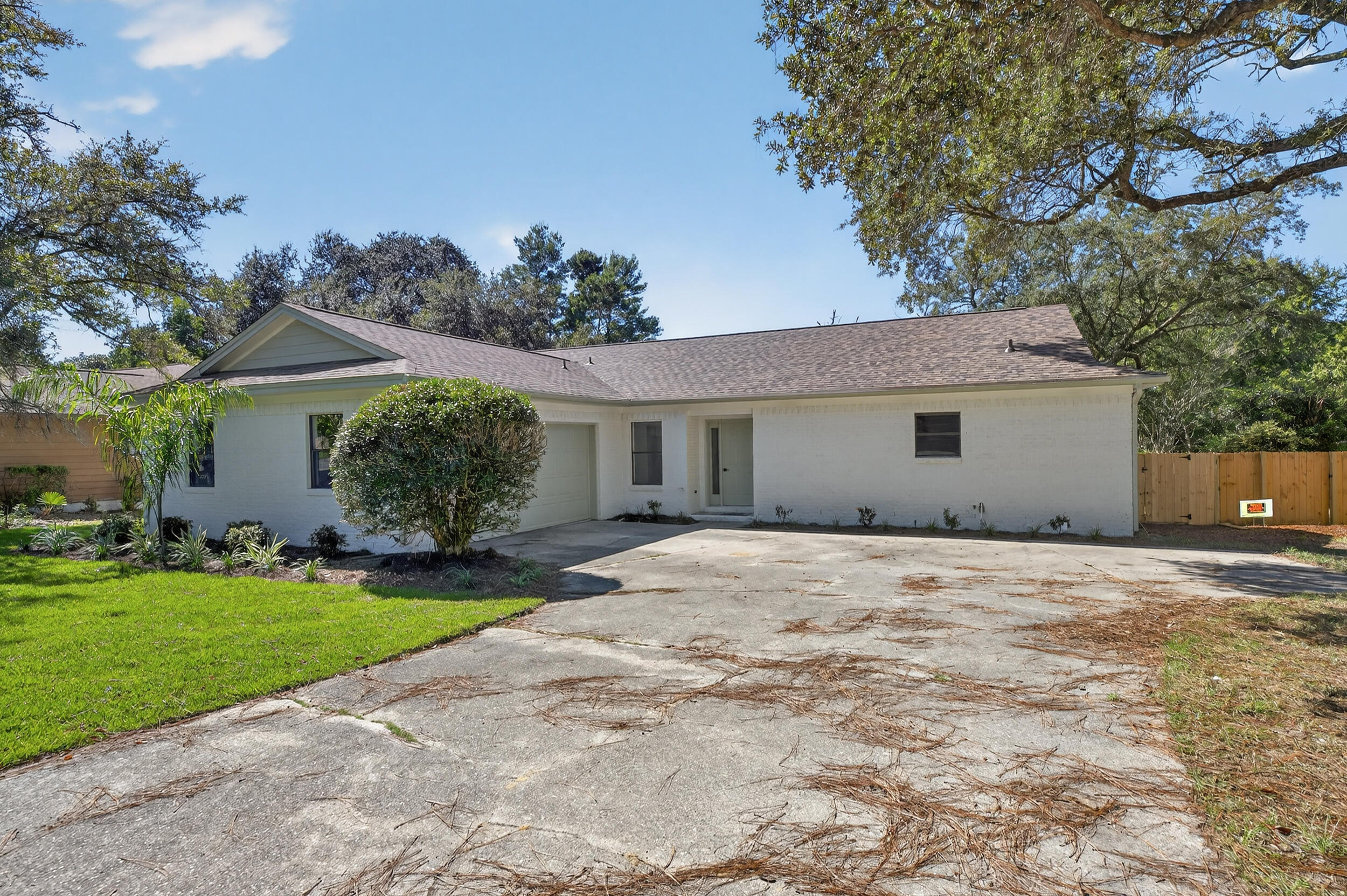 926 Ridgewood Way Niceville, FL 32578 - Photo 2 of 68 a front view of a house with a garden and yard