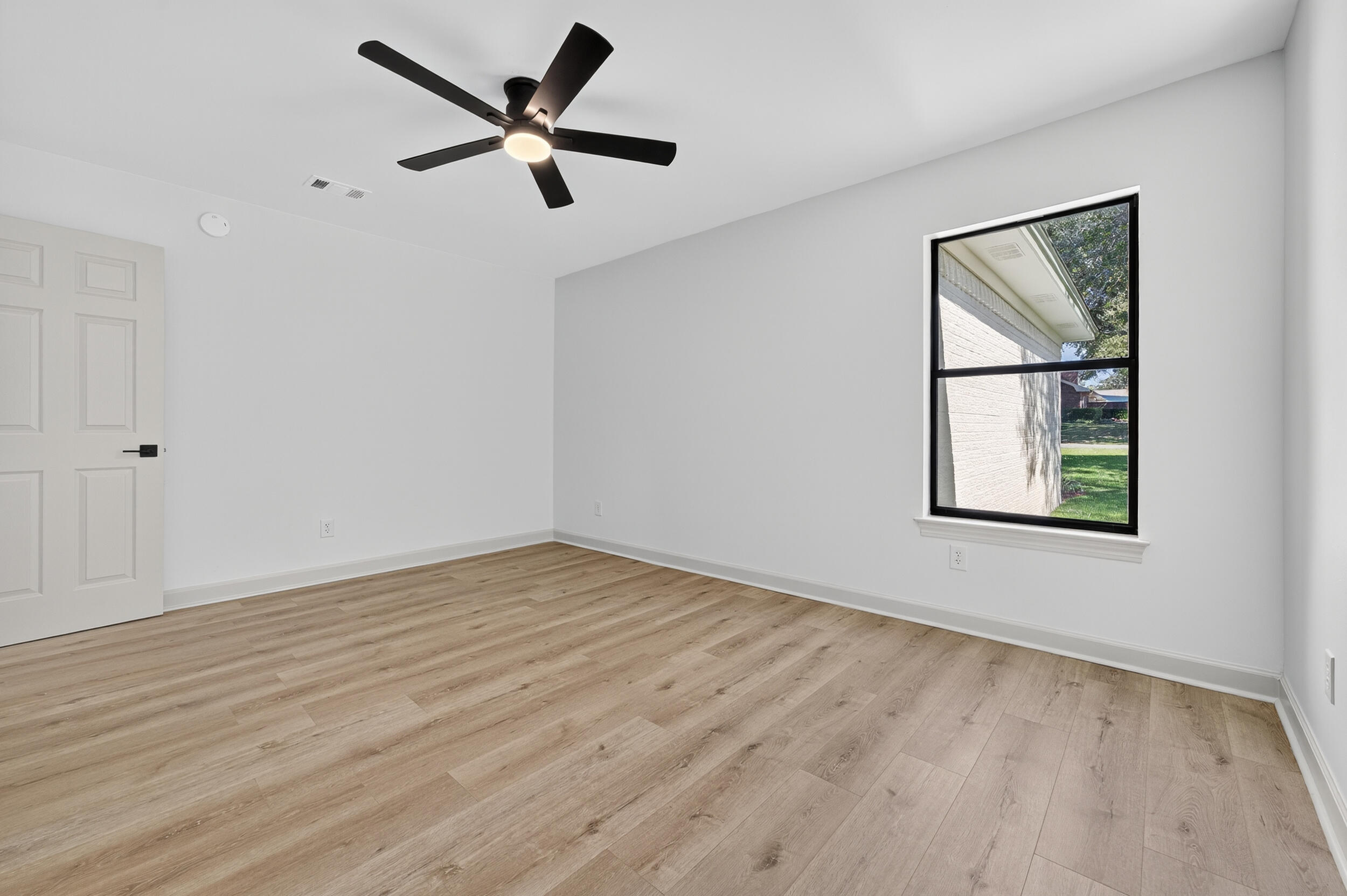 926 Ridgewood Way Niceville, FL 32578 - Photo 31 of 68 a view of an empty room with a window and wooden floor
