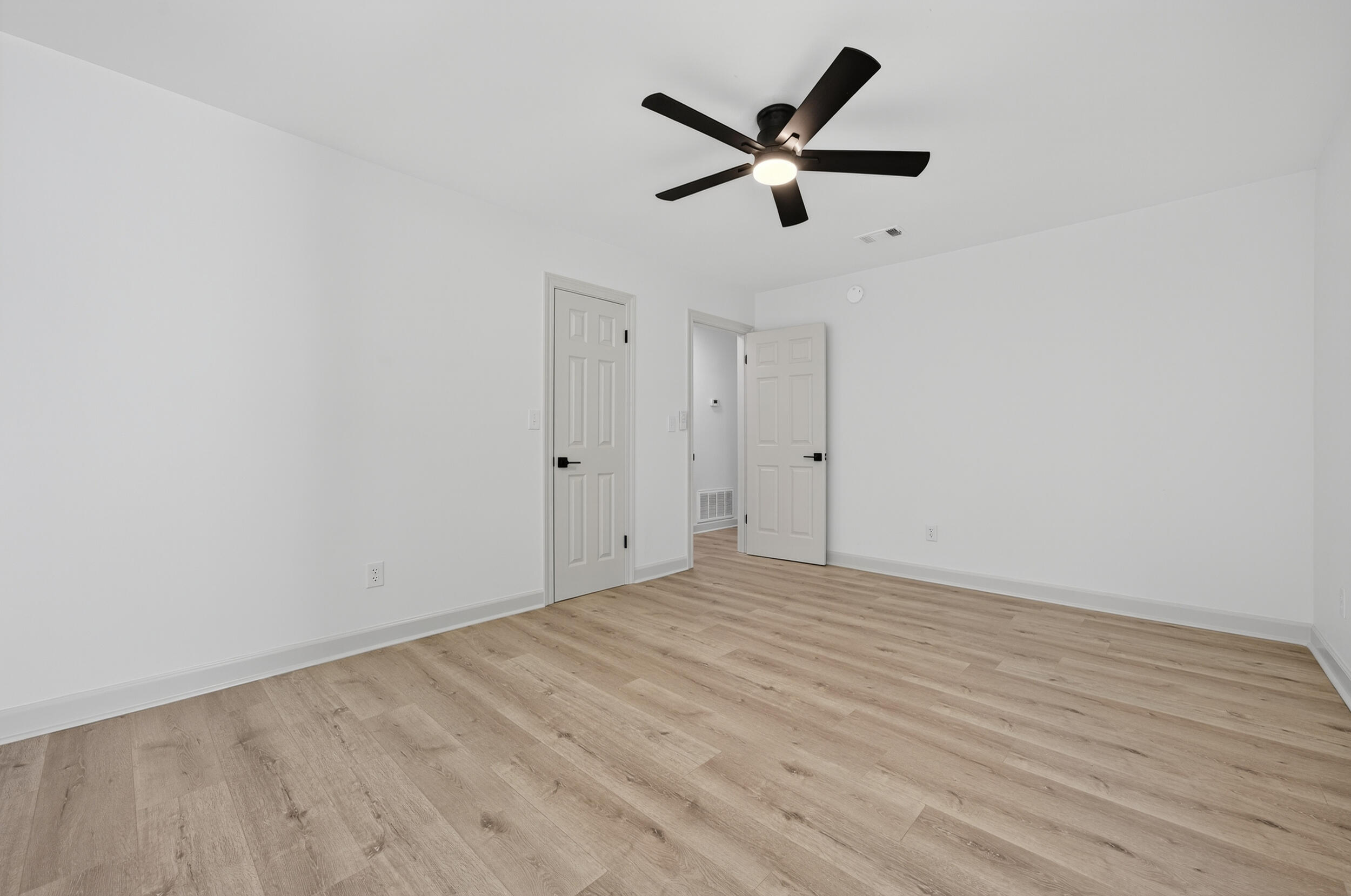 926 Ridgewood Way Niceville, FL 32578 - Photo 32 of 68 an empty room with wooden floor and ceiling fan