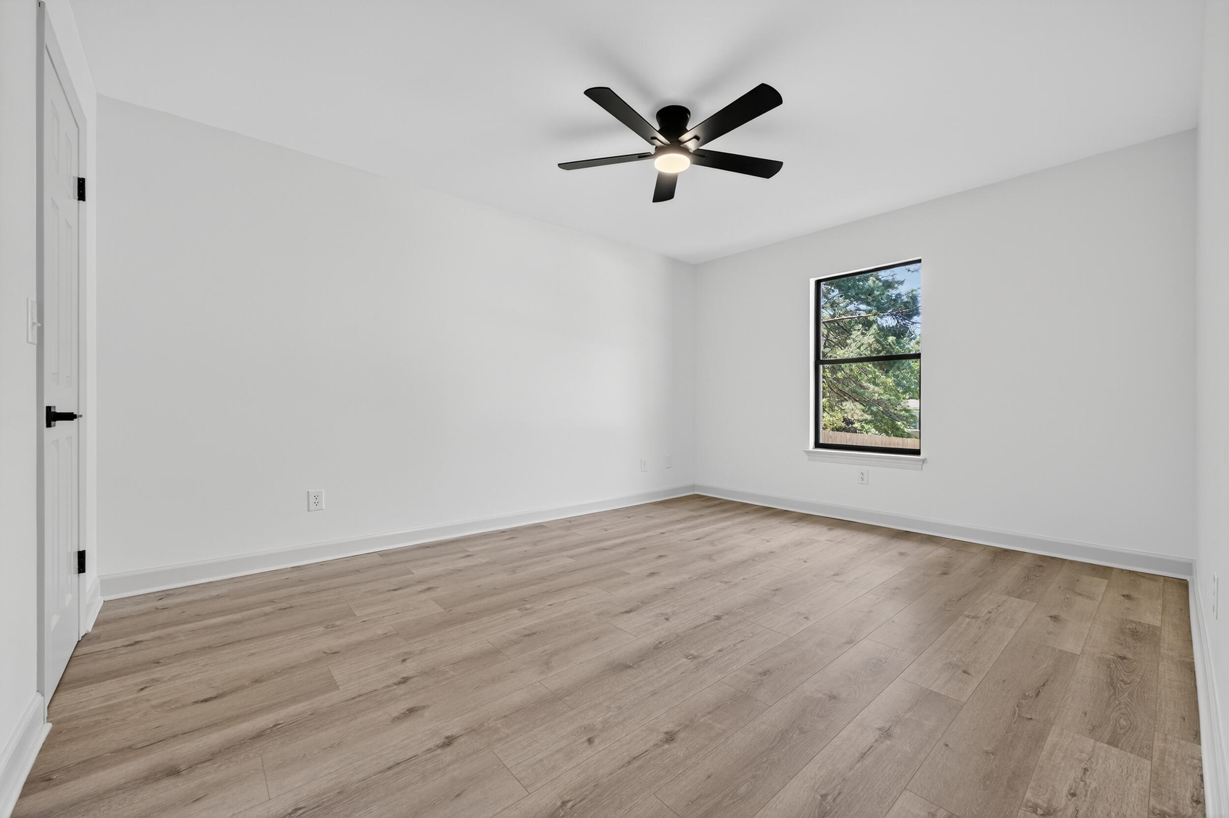 926 Ridgewood Way Niceville, FL 32578 - Photo 36 of 68 an empty room with wooden floor and windows