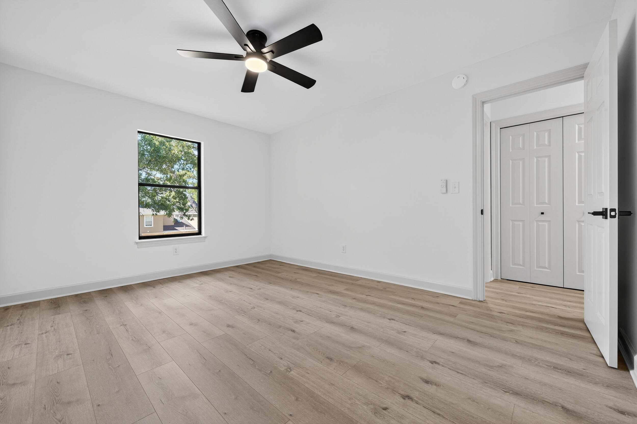 926 Ridgewood Way Niceville, FL 32578 - Photo 37 of 68 an empty room with wooden floor ceiling fan and windows